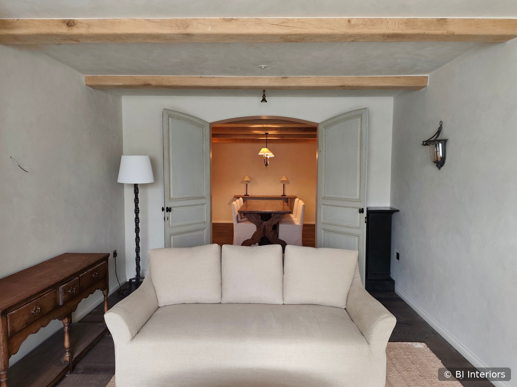 Finished traditional interior with exposed timber beams and double doors by BI Interiors